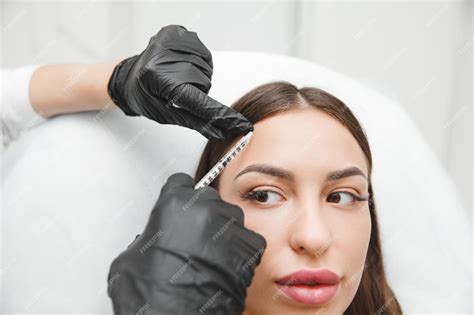 Premium Photo A Cosmetologist Makes Antiaging Injections Against