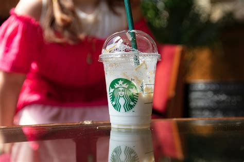 Half Empty Starbucks Cup Set On Table · Free Stock Photo