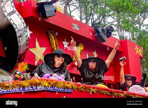 Members Of Krewe De La Dauphine Ride A Mardi Gras Float During The