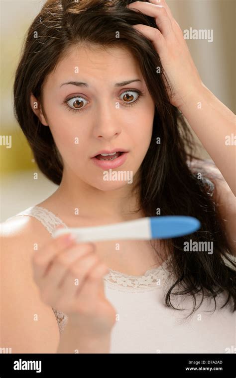 Worried Woman Looking At Pregnancy Test Unhappy About Result Stock