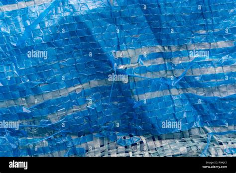 Macro Photo Of Very Worn Blue Cheap Poly Tarpaulin Exposed Inner