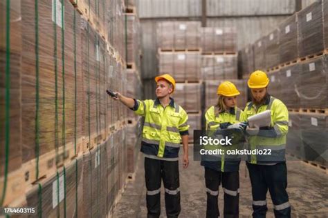 Warehouse Staff Verify Wooded Pallets Items Using Handheld Device