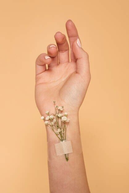 Free Photo Close Up Hand With Band Aid And Flowers