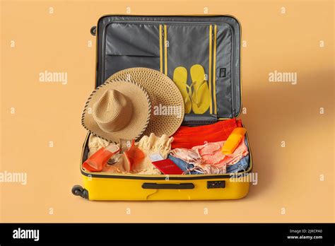 Open Suitcase With Clothes Passport And Ticket On Color Background