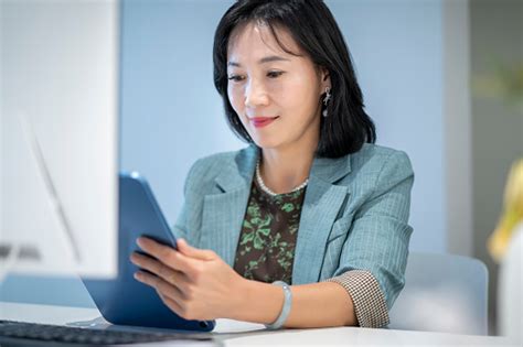 An Asian Female Whitecollar Worker Is In The Office Stock Photo