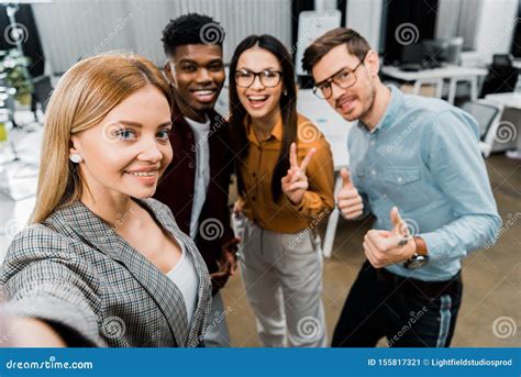 Camera Point Of View Of Smiling Multicultural Colleagues Taking Selfie