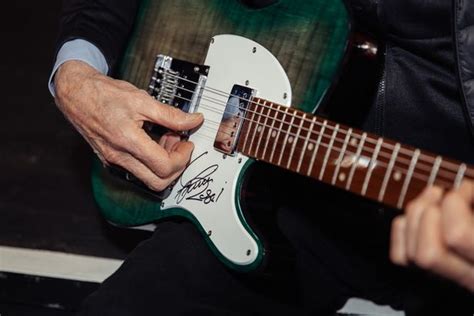 Status Quo Legend Francis Rossi Signs Guitar For Charity Auction At