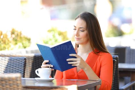 Serious Woman Reading a Book in a Coffee Shop Stock Image - Image of ...