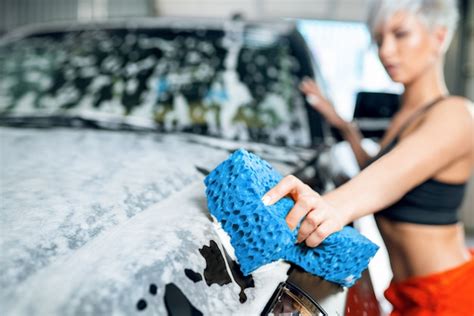 Premium Photo Sexy Young Woman Washes A Car In A Car Wash