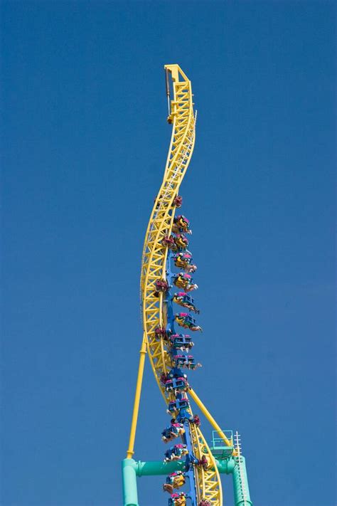 the roller coaster at an amusement park against a blue sky with no one in it