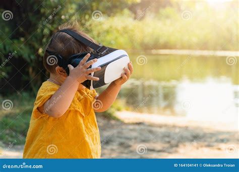 Virtual Reality Headset On Baby Outdoors Early Education Or Games With