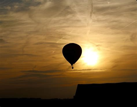 Premium Photo Silhouette Hot Air Balloon Against Orange Sky