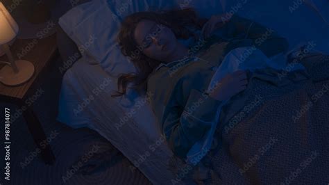 Woman in pajama sleeping in bed in dark apartment room, monster hiding ...