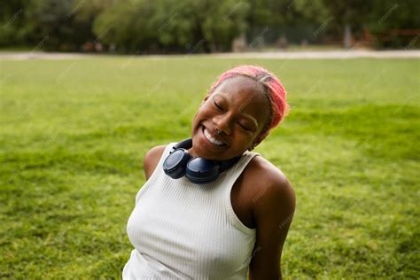 Premium Photo Portrait Of Braless Woman Outdoors With Headphones