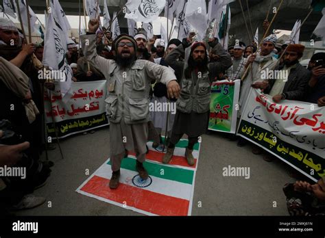 Pakistani Protesters Symbolically Stand On An Indian Flag And Shout