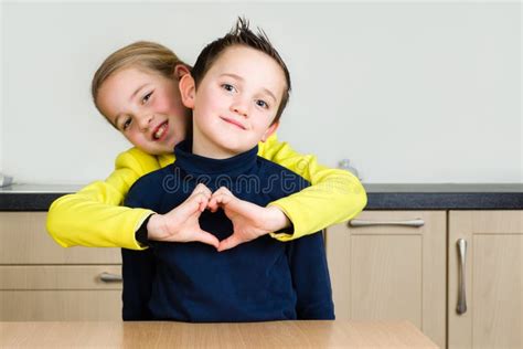 Siblings Hug Forming a Heart with Hand Stock Photo - Image of happiness ...