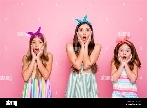 Portrait Of Impressed Girls With Color Headbands Screaming Omg Touching Their Cheeks Hearing