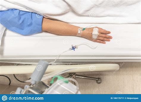 Patient On Hospital Bed In Medical In Patient Ward Resting With Iv