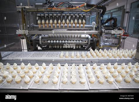 Yili torch ice creams are being produced on the assembly line at a ...