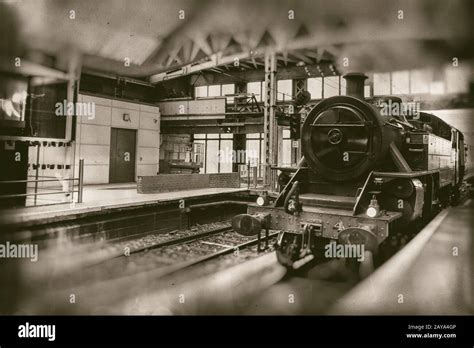 Old steam train, vintage locomotive entering train station Stock Photo ...