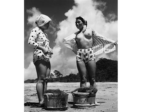 Two Women Standing Next To Each Other In Bathing Suits