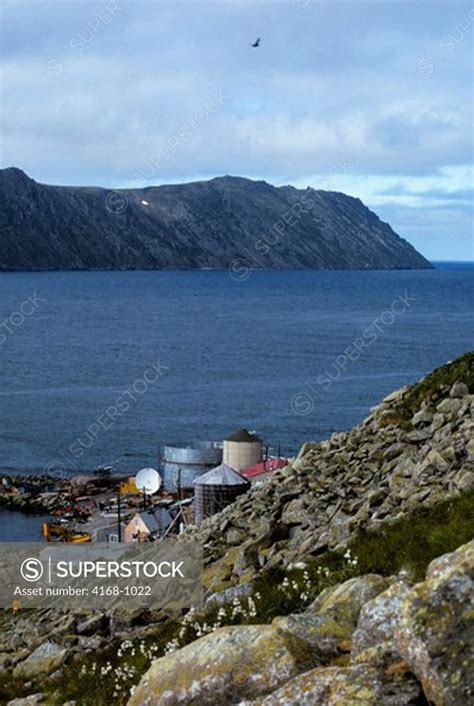 USA, ALASKA, LITTLE DIOMEDE ISLAND, INUIT VILLAGE WITH BIG DIOMEDE ...