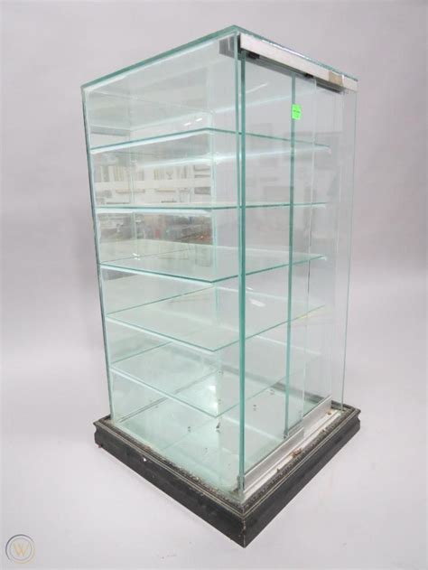 Glass tower display case with shelves and sliding doors | #3830601283