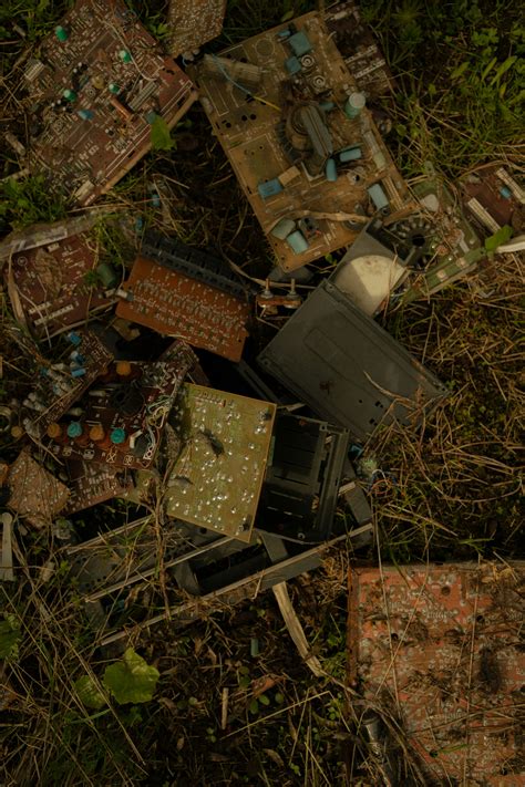 A pile of old broken electronics in the grass photo – Free Building