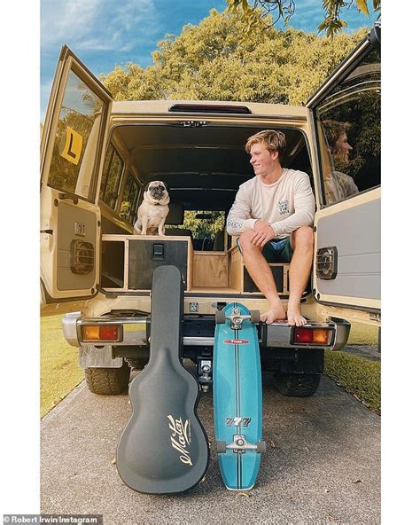 Robert Irwin 18 Poses With His Guitar And Skateboard Ahead Of A Road