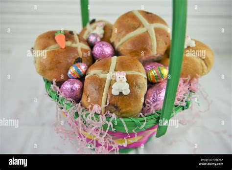 Easter Food In A Basket With Hot Cross Buns And Chocolate Easter Eggs And Decorations Stock