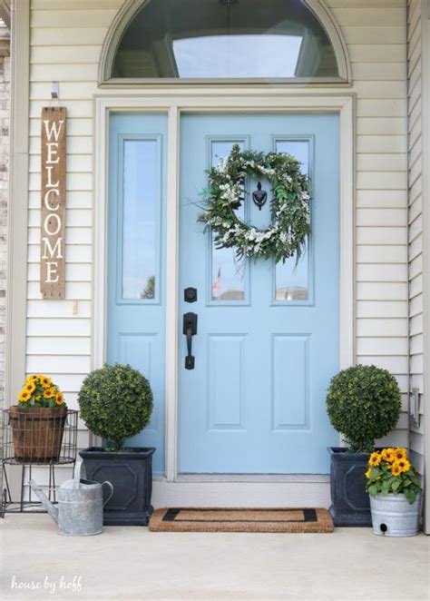 The Front Door Is Decorated With Pumpkins And Other Decorations