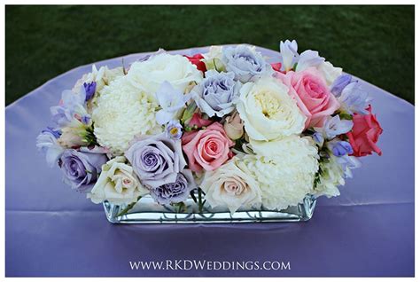 Freesia, garden roses, standard roses and fuji mums create a chic, garden feel in this ...