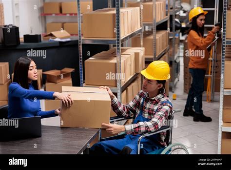 Warehouse Managers Handling Package In Post Office Storage Room