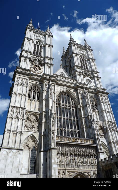 Front Of Westminster Abbey With Blue Sky And White Clouds Stock Photo