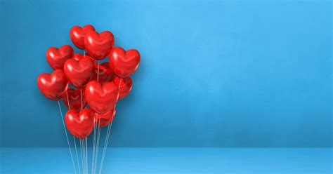 Premium Photo Red Heart Shape Balloons Bunch On A Blue Wall