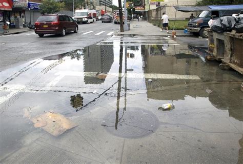 Sewage Drain Clogged Causing Flood On Street Corner Bronx NY Editorial