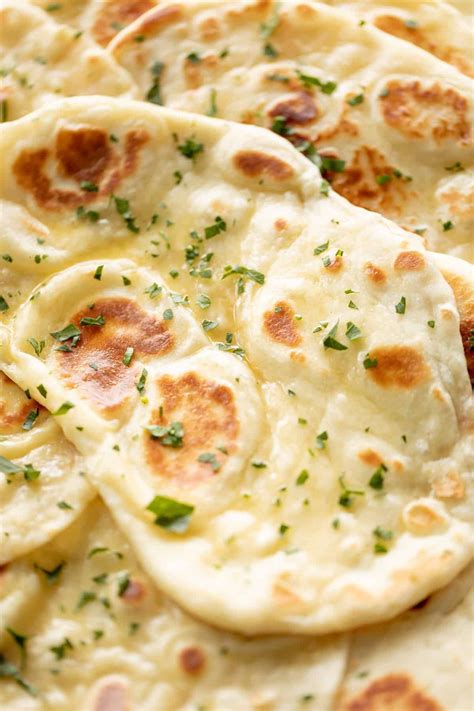 Naan Bread Brushed With Garlic Butter And Topped With Fresh Chopped