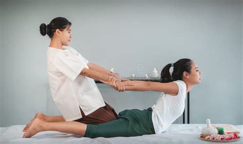 Woman Receiving Back Massage Stretching In Thai Therapy Spa Treament