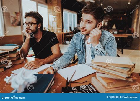 Portrait Of Two Pensive Writers Working Indoors Stock Photo Image Of