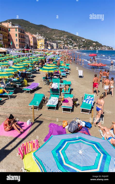 Beach at Alassio (ITALY) with people sunbathing Stock Photo - Alamy