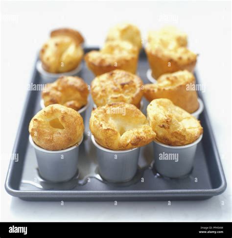 Yorkshire Pudding Baked In Nine Dariole Moulds On A Baking Tray Stock