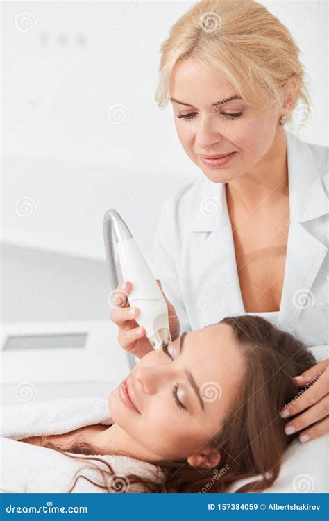 Relazed Beautiful Brunette Woman Having Facial Treatment In Beauty