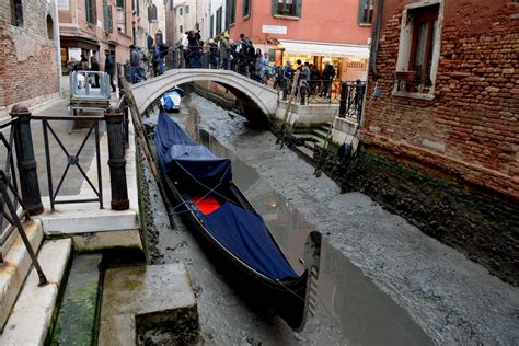 Venice's famous canals dry up after low tides and weeks without rain