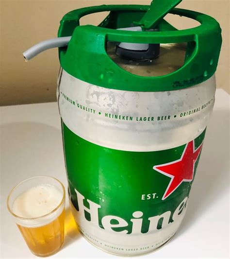 A Can Of Heineken Next To A Glass Of Beer