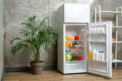 Premium Photo White Refrigerator With Open Door Showing Food Inside