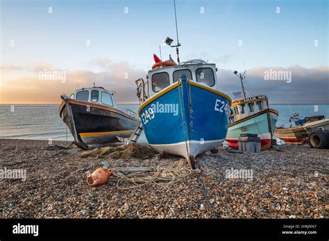 Fishing Boats Pulled Up On Shingle Beach At Sunrise Beer Jurassic