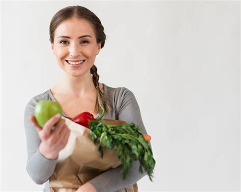 Free Photo Beautiful Woman Holding Paper Bag With Fruits And Vegetables