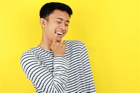 Flirty Of Handsome Young Asian Man Biting Finger On Yellow Stock Photo