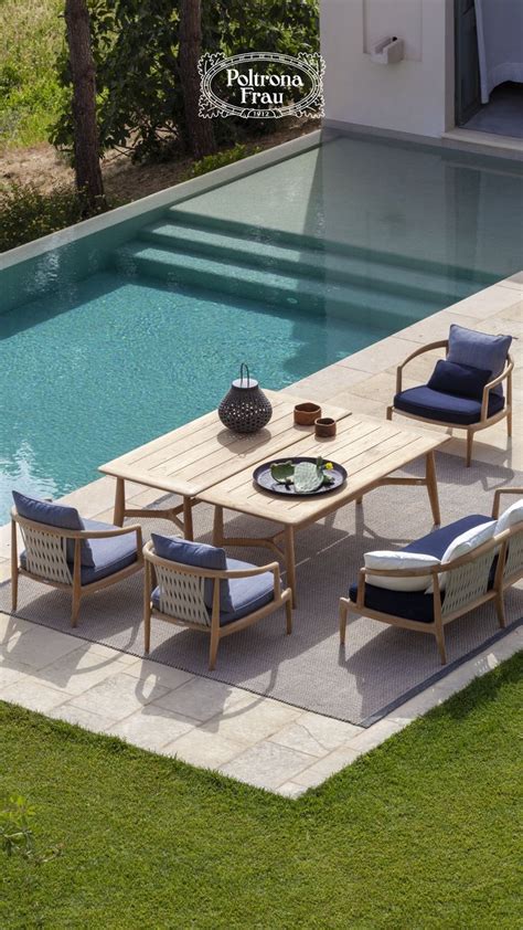 An Outdoor Dining Table And Chairs Next To A Swimming Pool