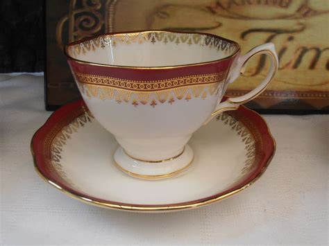 An Antique Tea Cup And Saucer With Gold Trim